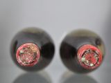 two bottles of wine that are sitting on a table