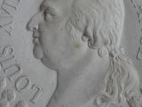 a close up of a coin with a man ' s face on it