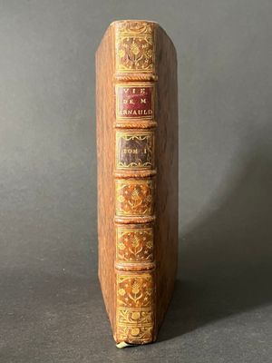 an old book with a wooden cover sitting on top of a table