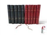 several books are lined up in a row on a white surface