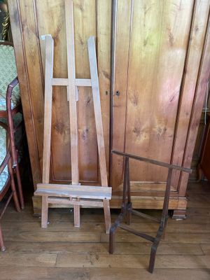 two wooden chairs and a wooden easer in a room