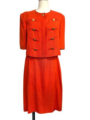 an orange dress and jacket on a mannequin mannequin mannequin mannequin mannequin mannequin mannequin mannequin mann