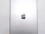 an apple ipad sitting on top of a white table next to a white wall