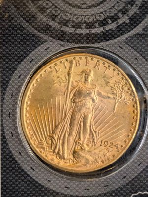 a close up of a gold coin with a woman on it