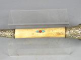 a small metal object with a wooden handle on it