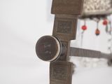 a metal object with a clock on it in the snow