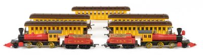 three toy trains that are sitting on a white surface