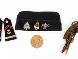 an image of a hat, scarf, medal, and other items on a white surface
