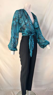 an image of a mannequin wearing a blue top and black pants
