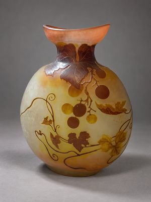 a vase with a design on it sitting on a table
