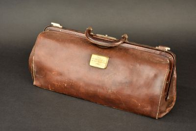 brown leather briefcase on a black background with a black background