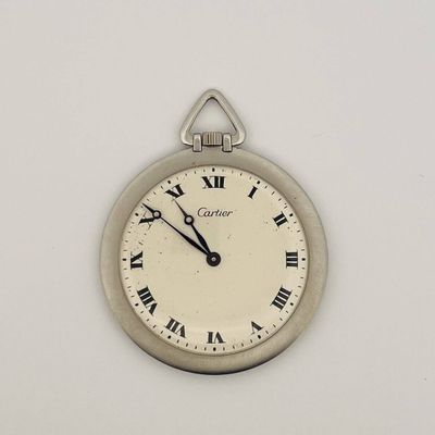 a close up of a clock on a wall with roman numerals
