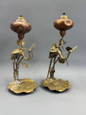 pair of antique brass candlesticks with figurines of a man and woman