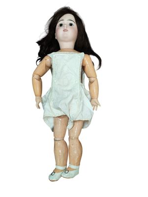 an image of a doll with black hair and a white dress