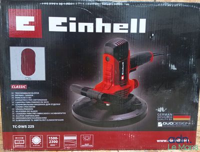 the box of a small electric sander on a wooden surface
