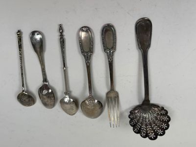 several spoons, forks and spoon spoons are lined up on a white surface