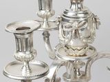 a silver candelab with a candle holder on it