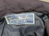 the back of a black jacket with a blue label on it