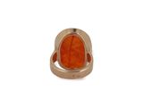 an image of a gold ring with an orange stone in it