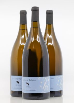 three bottles of wine sitting next to each other on a white surface