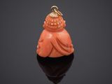 an orange jade buddha pendant with a gold clasp