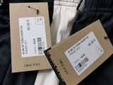 two tags on the back of a pair of men ' s pants