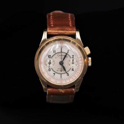 a close up of a watch on a black background
