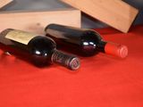 two bottles of wine sitting next to each other on a table