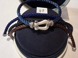 three bracelets that are sitting on top of a case