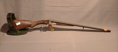 an old gun with a wooden barrel on a stand on a white background