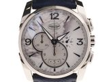 a close up of a watch on a white background with a blue strap
