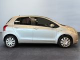 a picture of a small silver car parked in a garage