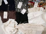 a lot of clothes that are sitting on a table