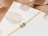 a picture of a necklace and a pair of earrings on a table