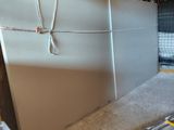 a refrigerator that is sitting in the middle of a room