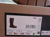 a box with a pair of brown boots on top of it