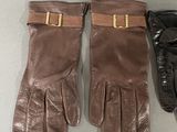 three pairs of leather gloves with gold buckles on them