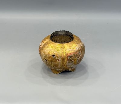 a small vase with a design on it on a white surface