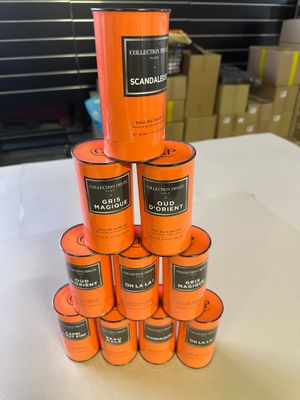 several cans of orange paint stacked on top of each other on a table