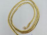 a gold plated necklace and bracelet set on a white surface