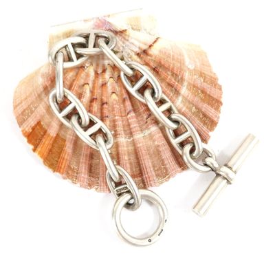 a shell with a chain and a cross on it