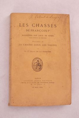 un vieux livre posé sur une table, à côté d'une nappe blanche