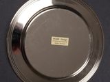 a silver plate with a label on it on a table