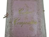 an old book with gold writing on a pink cover