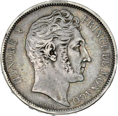 gros plan d'une pièce de monnaie sur laquelle figure un visage de femme