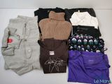 a lot of clothes that are sitting on a table