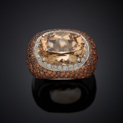 an orange and white diamond ring set in 18k white gold
