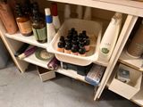 a shelf with bottles and containers on it in a bathroom