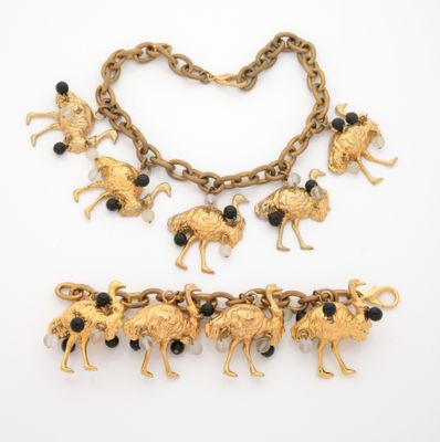 a close up of a necklace and bracelet on a white surface