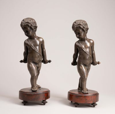 pair of antique bronze figurines of a boy and a girl